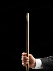 Professional conductor with baton on black background, closeup. Space for text