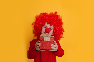 Funny kid clown playing at home. 1 April Fool's day concept.