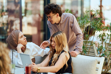 A Diverse MultiEthnic Group Reviewing Projects During a Work Break in a Caffee.