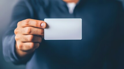 A person holding up a blank card