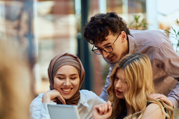A Diverse MultiEthnic Group Reviewing Projects During a Work Break in a Caffee.