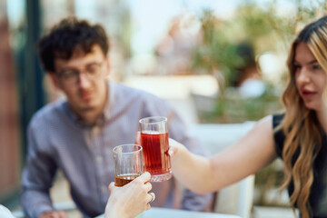 Diverse Teenagers Sitting in a Caffee, Toasting to a Work Moment of Celebration.