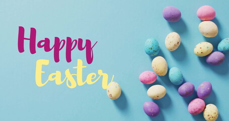 Fototapeta premium Image of happy easter text over easter eggs