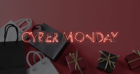 Image of cyber monday text over shopping bags and presents