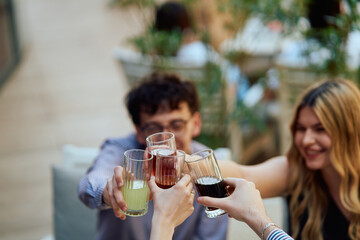 Diverse Teenagers Sitting in a Caffee, Toasting to a Work Moment of Celebration.