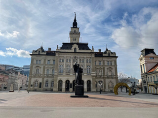 Fototapeta premium A building with intricate architectural details, situated in a spacious city square. Novi Sad, Serbia.