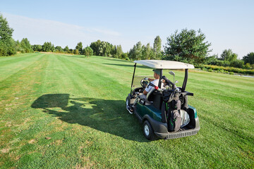 A golfer with a prosthetic leg practices their swing on a beautiful sunny day, utilizing an...