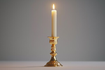 a candle is lit on a gold pedestal with a white background and a shadow of a candle on the wall