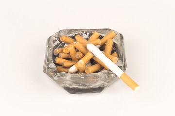 Ashtray butts cigarette on white