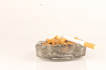 Ashtray butts cigarette on white
