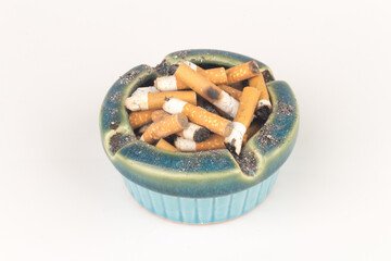 Ashtray butts cigarette on white