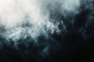 Fototapeta premium White powder exploding creating a smoke effect on a black background, perfect for overlays and textures