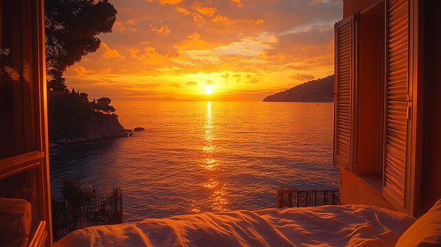 Fototapeta Stunning sunset view from bedroom window overlooking ocean.