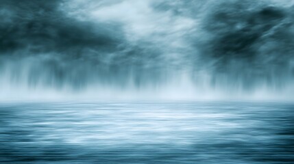 Atmospheric clouds and watery surface meet in blurred shades of blue