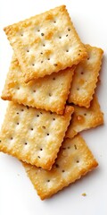 A close-up of crispy salted crackers stacked on a white background. Ideal for food-related projects, recipes, or snack presentations. Enjoy the delicious texture!