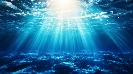 Obraz premium A mesmerizing underwater scene capturing the serene and mysterious depths of the ocean. Sun rays penetrate through the water, casting a beautiful gradient of blue hues. The ocean f