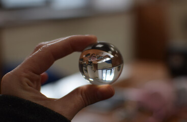 Flower Reflected Inside a Glass Ball Held by Hand, Macro Reflection Photography