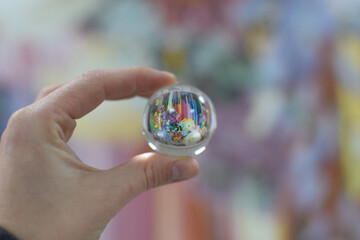 Flower Reflected Inside a Glass Ball Held by Hand, Macro Reflection Photography