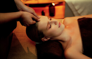 Caucasian woman enjoying relaxing anti-stress head massage and pampering facial beauty skin...