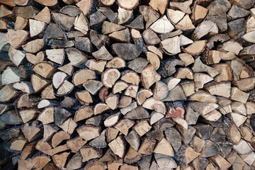 View of a Stack of Firewood. Background of Dry Chopped Logs in a Woodpile. Natural Texture....