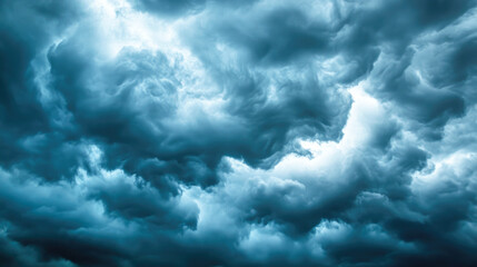 Fototapeta premium Dramatic blue storm clouds in dynamic sky with intense atmospheric swirls