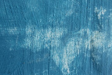 The texture of the blue cement wall is still not completely painted because there are still white spots for the background and copy space for the text. The wall is textured with an uneven surface