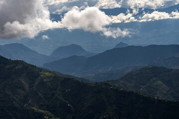 Obraz premium Rain clouds in dark tones in the Andean mountain range of Colombia, a dramatic landscape scene. Silhouette of mountains in the midst of a storm.
