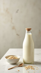A glass bottle of milk next to a bowl of cereal on a table.