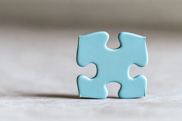 serene blue puzzle piece rests on soft neutral surface to symbolize autism awareness with ample copy space for your
