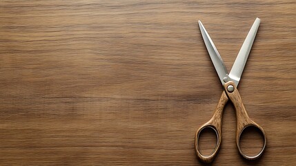 Wooden handled scissors on a brown wood background.