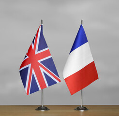 Table flags United Kingdom and France on grey blurred background
