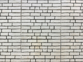 White brickwall texture on an exposed wall with cement and natural contour.