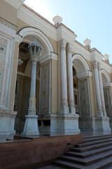 street lamp with carved decor near a building with arches and columns, Tashkent, Uzbekistan