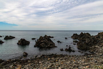 View of the rocky beach on a cloudy day