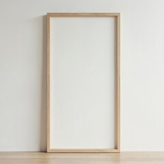 Blank wooden picture frame against light wall and floor. Mockup template for art, photos. Modern minimalist interior decoration, home decor. Empty frame, copy space, portrait or landscape format.