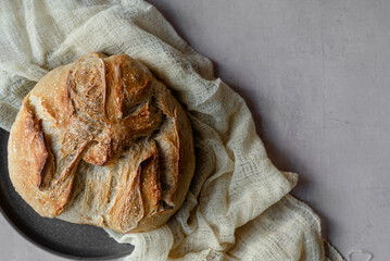 Rustic Artisan Sourdough Bread Loaf on Linen Cloth – Crusty Homemade Bread with Golden Brown Texture, Perfect for Food Bloggers, Bakeries, and Culinary Photography