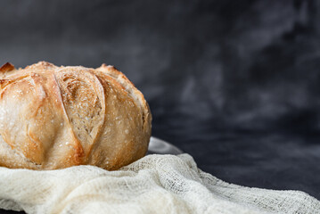 Rustic Artisan Sourdough Bread Loaf on Linen Cloth – Crusty Homemade Bread with Golden Brown Texture, Perfect for Food Bloggers, Bakeries, and Culinary Photography