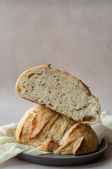 Artisan Sourdough Bread with Open Crumb – Crusty Homemade Loaf on Light Background for Bakeries, Food Bloggers, and Culinary Photography– Sliced in Half