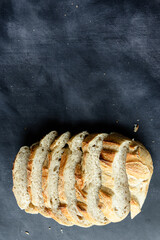 Overhead View of Sliced Artisan Sourdough Bread Arranged in a Pattern – Rustic Homemade Bread with Open Crumb and Golden Crust, Perfect for Food Bloggers and Culinary Design – Sourdough Texture
