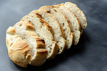 Overhead View of Sliced Artisan Sourdough Bread Arranged in a Pattern – Rustic Homemade Bread with Open Crumb and Golden Crust, Perfect for Food Bloggers and Culinary Design – Sourdough Texture