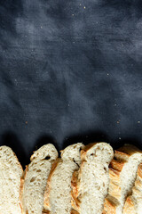 Overhead View of Sliced Artisan Sourdough Bread Arranged in a Pattern – Rustic Homemade Bread with Open Crumb and Golden Crust, Perfect for Food Bloggers and Culinary Design – Sourdough Texture