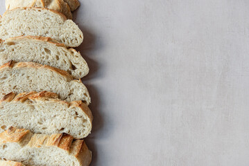 Overhead View of Sliced Artisan Sourdough Bread Arranged in a Pattern – Rustic Homemade Bread with Open Crumb and Golden Crust, Perfect for Food Bloggers and Culinary Design – Sourdough Texture