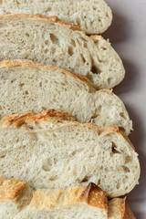 Overhead View of Sliced Artisan Sourdough Bread Arranged in a Pattern – Rustic Homemade Bread with Open Crumb and Golden Crust, Perfect for Food Bloggers and Culinary Design – Sourdough Texture