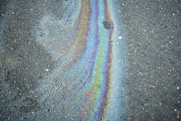 Colorful Oil Slick Patterns on Asphalt Near a Parking Lot During Daylight Hours
