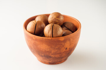 macadamia nuts in bowl on white background