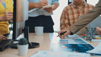 A diverse team engages in a dynamic meeting, analyzing data and developing strategies. The collaborative atmosphere showcases modern office tools and effective communication. SACTR