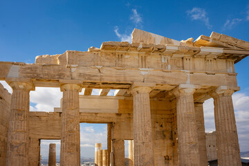 Obraz premium Architectural masterpiece, the Parthenon, a unique UNESCO world heritage archaeological site of Acropolis hill with beautiful scattered clouds and deep blue sky, Athens historic center, Attica, Greece