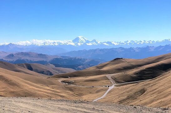 A panoramic view of the Andes Mountains from Cusco, with snow-capped peaks in the distance and an open road leading to them.  reread in the mountains of Ladakh