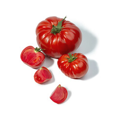 Red and pink tomatoes on a white background
