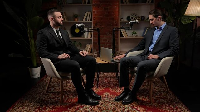 Two experts talking in a cozy, loft-style podcast studio